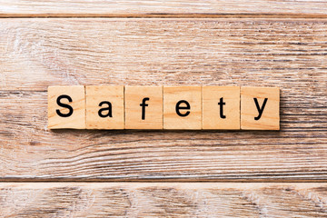 safety word written on wood block. safety text on wooden table for your desing, concept