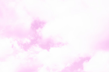 Pink pastel sky with fluffy white clouds. Looks like a marble texture