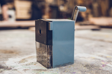 Mechanical pencil sharpener on wooden table - vintage