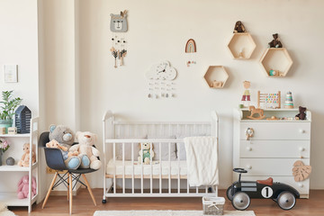 wooden toys in the children's room, chest of drawers and a white bed, the interior of the...