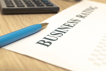 Business financial rating chart with pen, bank cards and calculator.