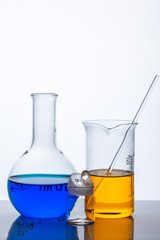 laboratory flask with blue and orange liquid