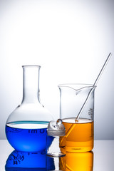 laboratory flask with blue and orange liquid