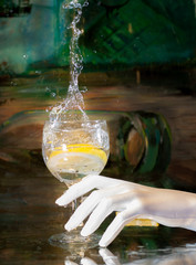 splashing glass of water with lemon