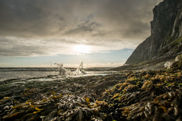 The water is splashing on a rock at Kvalvika Beach in Lofoten Island, Norway