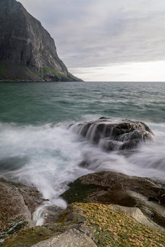 Silky smooth water over a rock at the beach of Kvalvika in Lofoten Islands, Norway © Michael