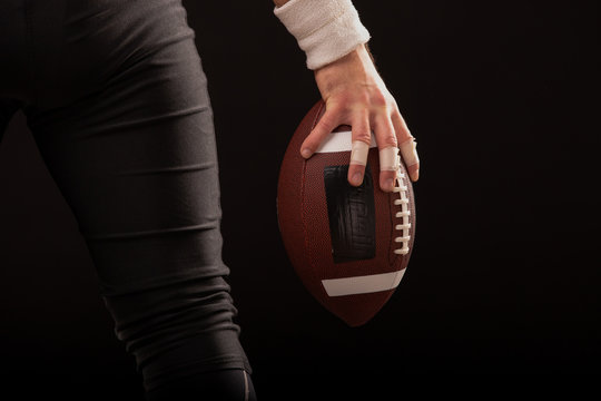 Cropped Image Of Sportsman Holding American Football Ball