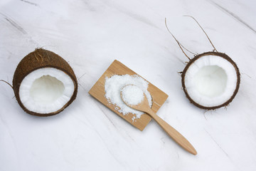 flat lay coconut and cocnut flakes  on a  marble table