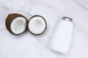 flat lay coconut and mock up white  plastic  bottle  on a  marble background