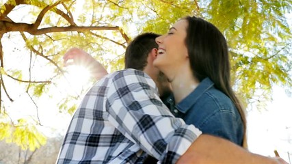 Happy couple meeting walk each other and hugging in a park