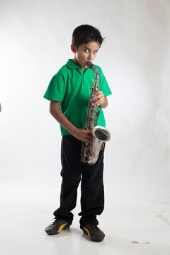 Indian Boy Child Playing Saxophone
