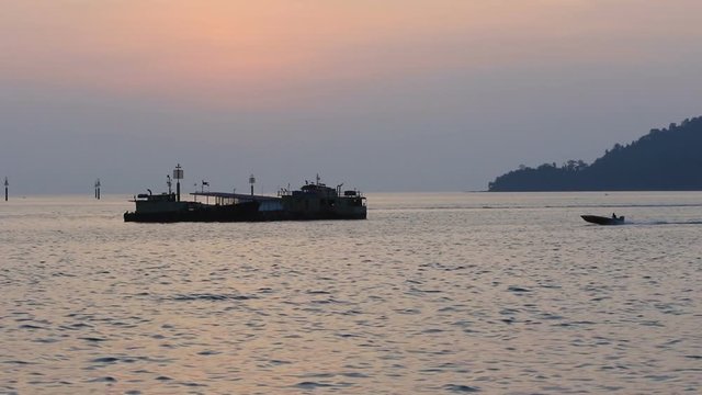 Footage of Fisherman boat Pass-by at Waterfront Kota Kinabalu, Sabah, Borneo during Beautiful sunseet .Kota Kinabalu waterfront is famous tourist spot during sunset.