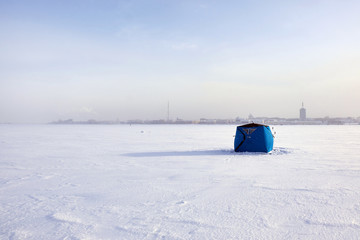tent for winter fishing on the river