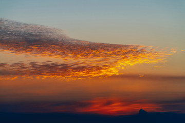 Sunny shine on clouds. Wonderful vivid dawn. Beautiful calm sunset. Scenic tranquil sunrise. Amazing peaceful cloudy sky. Sun above horizon. Picturesque sundown. Atmospheric cloudscape. Background.