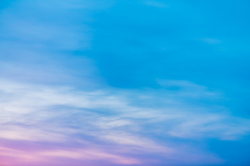 Sunset sky with pink lilac light clouds. Colorful smooth blue white sky gradient. Natural sunrise background. Amazing heaven at morning. Slightly cloudy evening atmosphere. Wonderful weather on dawn.