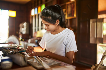 Fototapeta na wymiar thai teen girl doing homework and studying at home