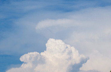 White fluffy clouds against a blue sky,