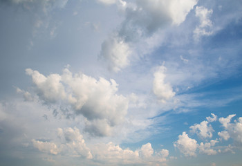 Fototapeta na wymiar White fluffy clouds against a blue sky.