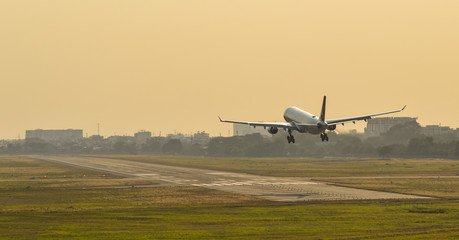 Plane landing at the airport on sunset