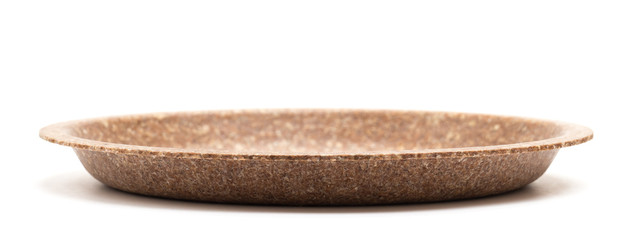 Biodegradable edible plate made from wheat bran isolated on white background, low angle view