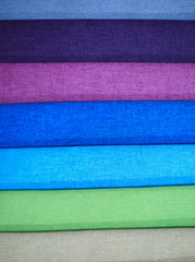 Textile samples. Textile samples for curtains. Blue purple, green tone curtain samples hanging.