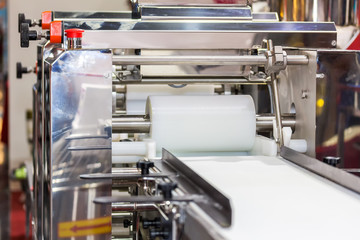 close up cylindrical die and belt conveyor of automatic food making machine for chinese or asian food steamed stuffed buns (production line for high technology industrial food manufacturing)