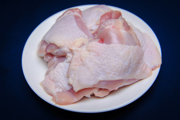Raw chicken ingredients on white dish