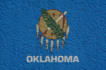 Obraz premium US State Politics Or Business Concept: Oklahoma Flag Wall With Plaster, Background Texture