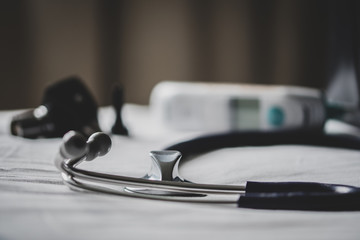 A doctors bag at a clinic - showing stethoscope, otoscope and thermometer.