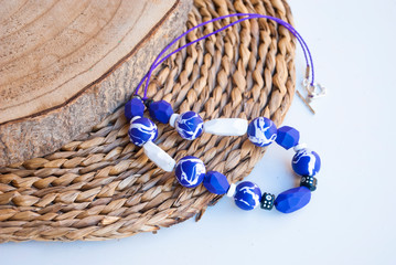 Casual bright deaded necklace. Handmade jewelry of polymer clay. Fashion background.