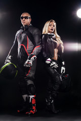 Fototapeta na wymiar Fashion couple model DJ and biker with headphones and sunglasses, black leather jacket, leather pants, stylish pretty blonde woman and man in night casual outfit. Long wavy hairstyle.