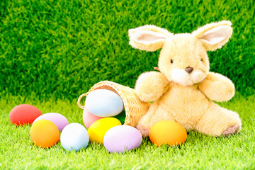 Bunny toy and Easter eggs in basket