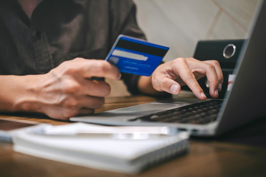 Businessman holding credit card and typing on laptop for online shopping and payment makes a purchase on the Internet, Online payment, Business financial and technology