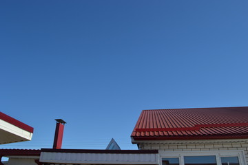 Naklejka premium Red roofs against the blue sky