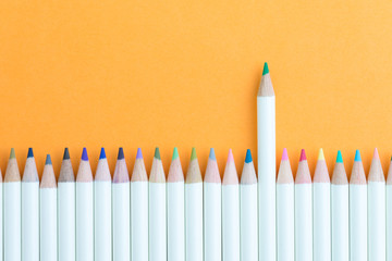 Color pencil in row with stand out green one using as unique, individual creativity, leadership idea