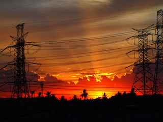 power line silhouette of electricity pylons at sunset