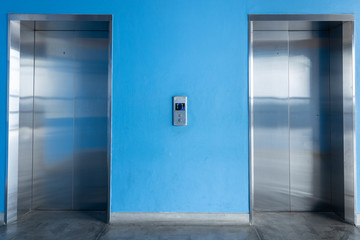 Front view of elevator with blue wall.