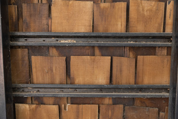 pieces of wooden plank wall with black steel shelves.