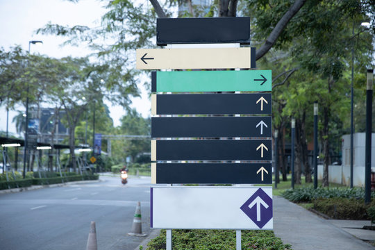 Blank steel signpost or guide post with direction arrows.