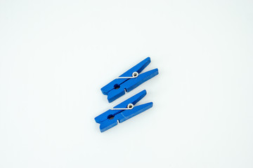 Cloth peg isolated on white background. Blue color.