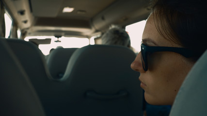 Young pretty woman sitting in a bus