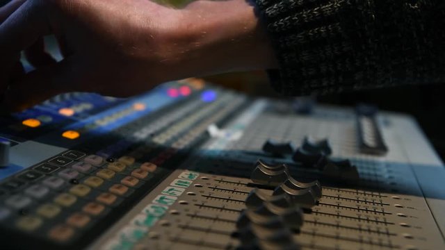 Mixing music on a recording studio mixing desk