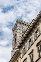 Fototapeta premium Italy,Florence, a large tall tower with a clock on the side of a building