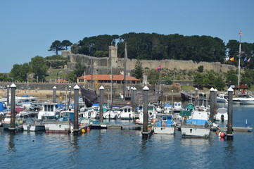 Fototapeta na wymiar Marina With Monterreal Castle At The Background In Bayonne. Nature, Architecture, History, Travel. August 16, 2014. Bayona, Pontevedra, Galicia, Spain.