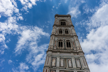 Fototapeta na wymiar Italy,Florence, Giotto's Campanile, a tall clock tower sitting under a cloudy blue sky with Giotto's Campanile in the background