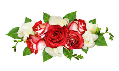 Red and white roses and freesia flowers and leaves in a floral arrangement