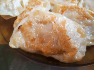 Fried Russian dumplings. A delicious dish on a plate. Ruddy dumplings. Delicious ready and traditional Polish dinner.