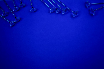 pins on blue background, copy space.