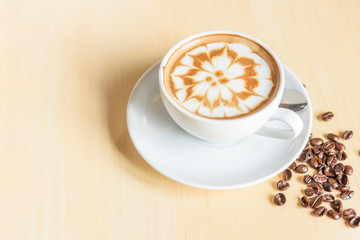 hot cappuccino with nice milk pattern in paw and coffee bean