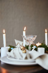 selective focus of candles and crystal glass on wooden table at home